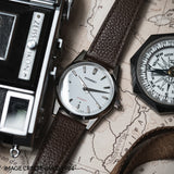 MB1 L03 White with brown leather strap on a map
