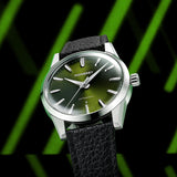 MB1 L07 Olive Green watch black strap with green lighting and black background